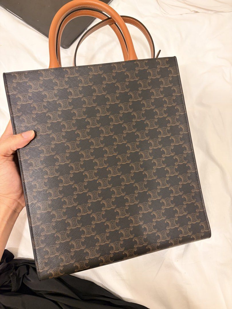 Celine Triomphe Canvas Vertical Tote Bag (Category: Luxury Bags & Wallets) located in Manila. Submitted by phfornow (Listing ID 1450436130, Image 3). Description: For - 69,999 Only - comes with Paperbag and Dust Bag Mall Price - 130-150k - Authentic Celine Vertical Mini Tote Bag - Iconic Triomphe canvas in brown - Features the signature Triomphe print - Durable leather handles and trim - Includes original dust bag - Ideal for everyday wear and st