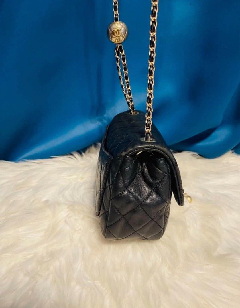 Chanel Black Quilted Leather Chain Shoulder Bag (Category: Luxury Bags & Wallets) located in Las Pinas. Submitted by japanthriftstore (Listing ID 1450446614, Image 3). Description: SUPER SALE🎌🎌🎌 - Classic Chanel black quilted leather shoulder bag - Gold chain strap with unique ball charm detail - Iconic CC logo clasp - Timeless statement piece Nasa picture yung maliit na flaws… at may konting color pink sa loob kayo na maglaba. As is where is 
