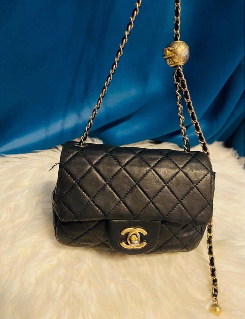Chanel Black Quilted Leather Chain Shoulder Bag (Category: Luxury Bags & Wallets) located in Las Pinas. Submitted by japanthriftstore (Listing ID 1450446614, Image 1). Description: SUPER SALE🎌🎌🎌 - Classic Chanel black quilted leather shoulder bag - Gold chain strap with unique ball charm detail - Iconic CC logo clasp - Timeless statement piece Nasa picture yung maliit na flaws… at may konting color pink sa loob kayo na maglaba. As is where is 