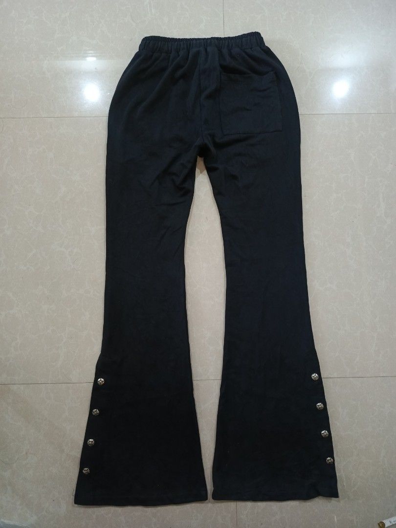 Chrome Hearts Black Flare Pants with Snap Buttons (Category: Other Bottoms) located in Cabatuan. Submitted by penthegreat (Listing ID 1450460995, Image 2). Description: No waisttag(off/legit) (11 Hem) (40.5 length)(11.5width) stretchable good for size 23-26 9/10 condition, minimal issue only pinholes - Black flare pants - Drawstring waist for adjustable fit - Snap buttons along the leg for styling options - Iconic Chrome Hearts logo on the front 
