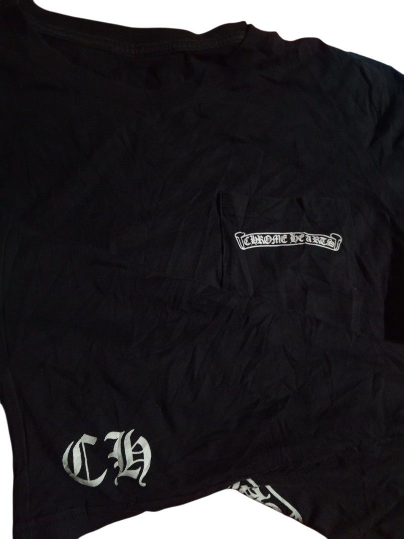 Chrome Hearts Black T-Shirt (Category: Tshirts & Polo Shirts ) located in Manila. Submitted by kents_thrift (Listing ID 1450500597, Image 3). Description: -Chrome hearts (19x25.5) - Small - Black Chrome Hearts T-shirt - Classic Chrome Hearts logo on the front pocket - Large, eye-catching graphic design on the back - 'CH' logo detail on the bottom left hem - Essential piece for any Chrome Hearts enthusiast.