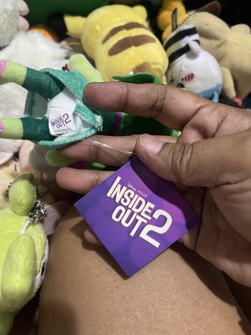 Disney Pixar Inside Out 2 Disgust Plush Keychain (Category: Plushies & Soft Toys) located in Muntinlupa City. Submitted by joanofarc1013 (Listing ID 1450347088, Image 3). Description: - Adorable Disgust plush keychain from Disney/Pixar's Inside Out 2. - Features a shiny gold-colored keyring. - Brand new with tag still attached. - Approximately 4-5 inches in height. - Ideal accessory for backpacks, purses, or bags..