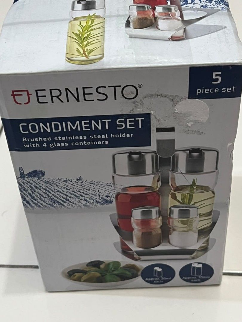 Ernesto 5 Piece Condiment Set - Brushed Stainless Steel Holder (Category: Other Kitchenware & Tableware) located in Penampang. Submitted by yuna80 (Listing ID 1450342009, Image 2). Description: - Ernesto condiment set - Brushed stainless steel holder - 4 glass containers included - Features shakers and larger bottles for oil/vinegar - Ideal for kitchen counter or dining table - Keeps your seasonings easily accessible.