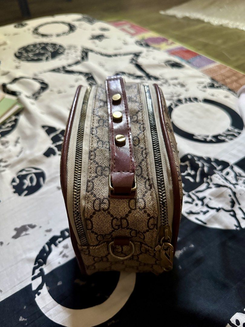GD Monogram Bee Charm Handbag (Category: Luxury Bags & Wallets) located in Talavera. Submitted by elledepartment (Listing ID 1450378095, Image 3). Description: Cute little handbag with GD monogram print. Has a bee charm on the front. Zipper closure. The interior is spacious. Perfect for carrying essentials. Burgundy trim and gold hardware. Great for daily use. Issue: No sling bag. Free only, just buy atleast one on my listings..