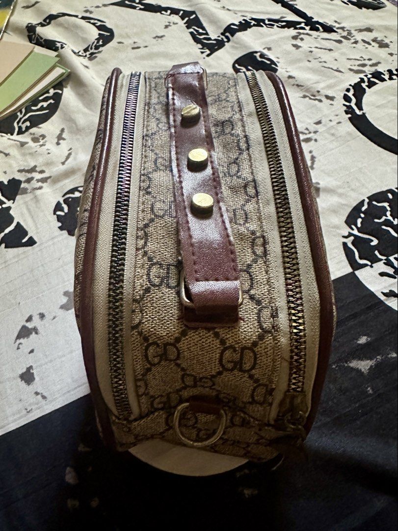 GD Monogram Bee Charm Handbag (Category: Luxury Bags & Wallets) located in Talavera. Submitted by elledepartment (Listing ID 1450378095, Image 2). Description: Cute little handbag with GD monogram print. Has a bee charm on the front. Zipper closure. The interior is spacious. Perfect for carrying essentials. Burgundy trim and gold hardware. Great for daily use. Issue: No sling bag. Free only, just buy atleast one on my listings..