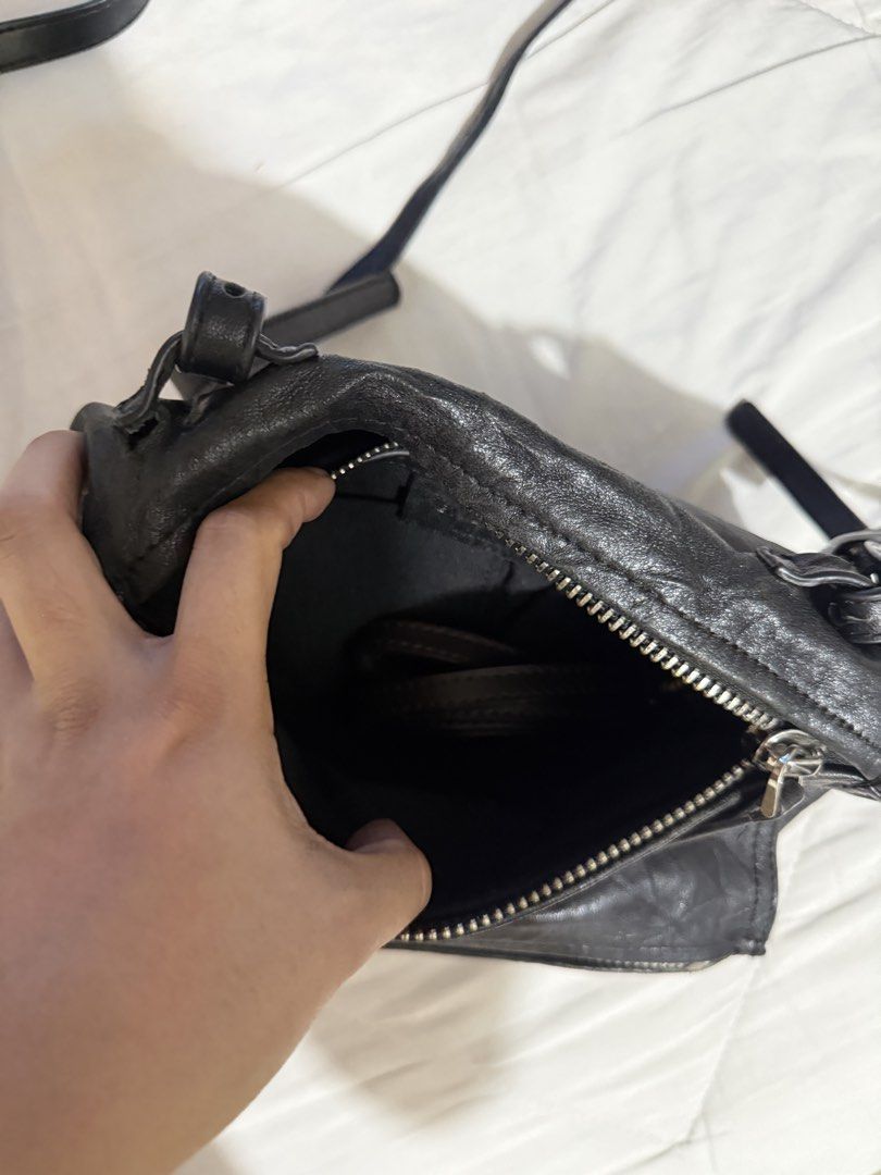 Givenchy Black Leather Nightingale Crossbody Bag (Category: Luxury Bags & Wallets) located in Quezon City. Submitted by msyouthberry (Listing ID 1450432126, Image 3). Description: - Givenchy crossbody bag in black leather. - Unique crinkled leather texture. - Two secure zippered compartments. - Adjustable strap for comfortable wear. - Spacious interior, ideal for everyday essentials. -Faulty zippers.