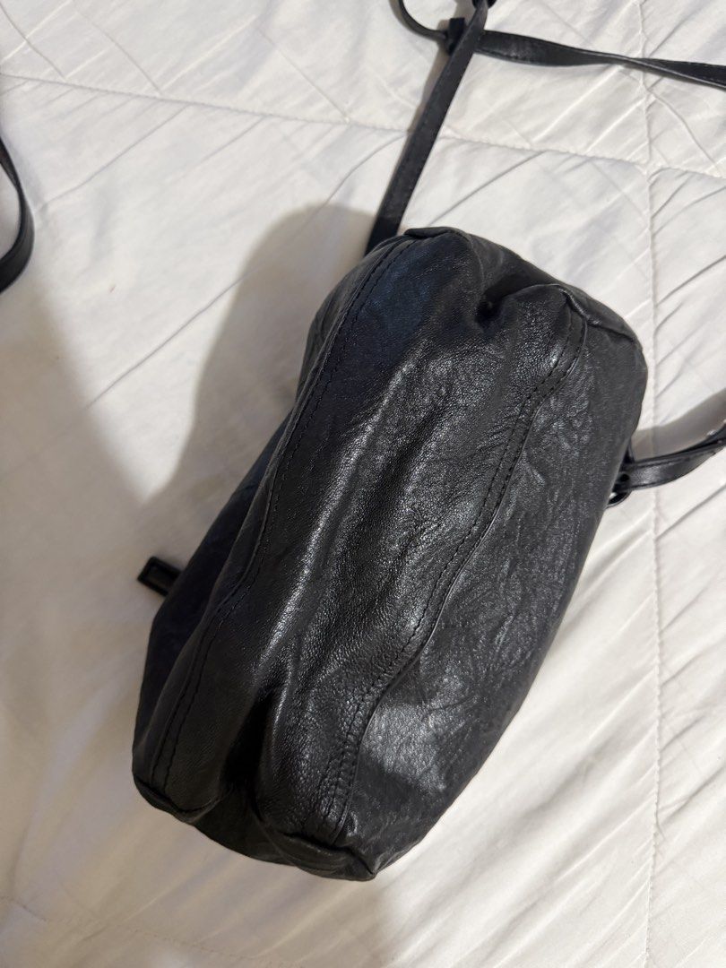 Givenchy Black Leather Nightingale Crossbody Bag (Category: Luxury Bags & Wallets) located in Quezon City. Submitted by msyouthberry (Listing ID 1450432126, Image 2). Description: - Givenchy crossbody bag in black leather. - Unique crinkled leather texture. - Two secure zippered compartments. - Adjustable strap for comfortable wear. - Spacious interior, ideal for everyday essentials. -Faulty zippers.