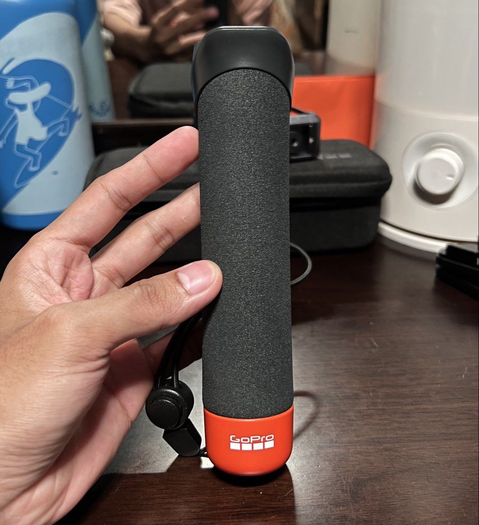 GoPro Floating Hand Grip (Category: Video Cameras) located in Cavite. Submitted by minja47 (Listing ID 1450374134, Image 1). Description: - Secure grip for your GoPro, ideal for water sports. - Bright orange color for easy visibility in water. - Textured surface ensures a firm hold. - Includes a wrist strap for added security. - Capture all your adventures with confidence..