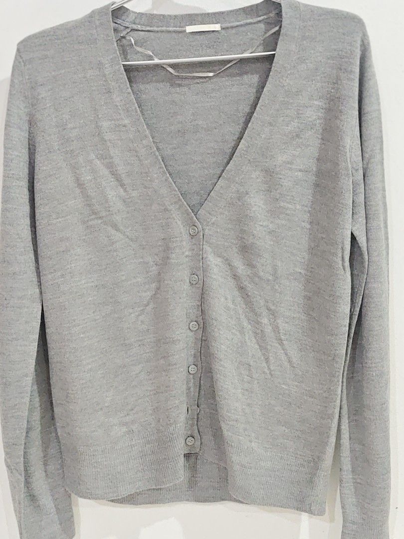 Grey V-neck Button-up Cardigan (Category: Coats, Jackets and Outerwear) located in Kuala Lumpur. Submitted by hurrul89 (Listing ID 1450405695, Image 1). Description: - Simple grey cardigan - V-neck with button closure - Long sleeves - Basic knit style - Small ribbon detail on inside seam - Ideal for layering.