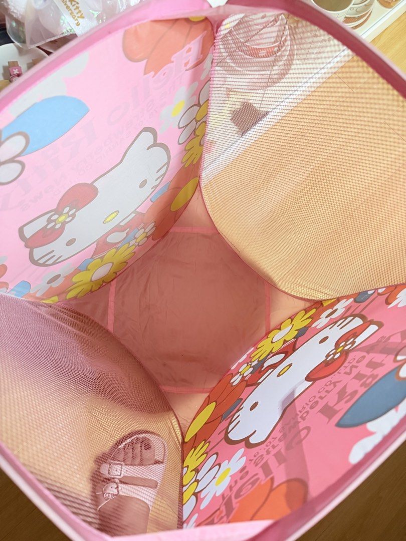 Hello Kitty Floral Collapsible Laundry Basket (Category: Laundry Baskets) located in Manila. Submitted by hellokittyjhoe (Listing ID 1450455665, Image 3). Description: - Adorable pink Kitty laundry basket - Features "The Strawberry News" design with Kitty and flowers - Collapsible for convenient storage - Mesh sides for ventilation - Sturdy handles for easy carrying - Ideal for kids' rooms or any Kitty enthusiast.