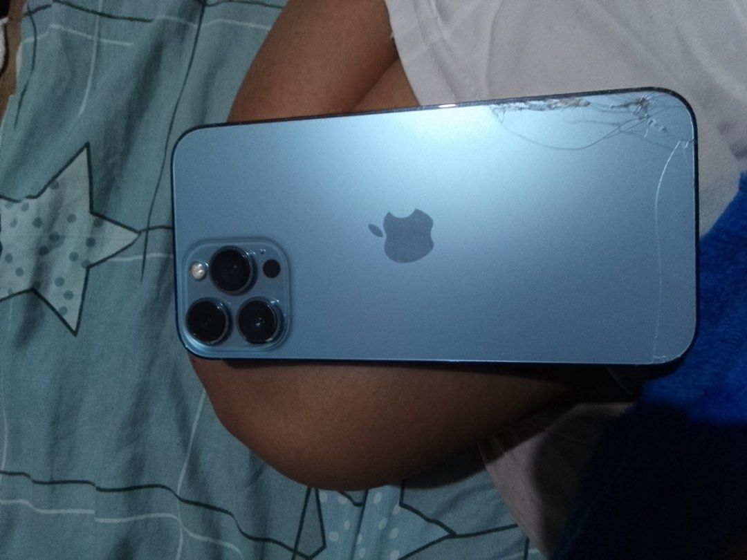 iPhone 13 Pro Max (Category: iPhone 13 Series) located in Manila. Submitted by ac_0915 (Listing ID 1450363224, Image 1). Description: Crack on lower part of back glass. Visible scratches on screen due to used without tempered. No history of repair. 85% BH 512 GB .