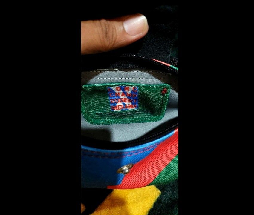Longchamp Le Pliage Cuir Small Top Handle Bag (Category: Luxury Bags & Wallets) located in Bay. Submitted by silverhorse-59c851 (Listing ID 1450324227, Image 3). Description: - Cute and small Longchamp bag - Colorful abstract print on durable canvas - Black leather trim for a stylish finish - Comfortable top handles - Includes a detachable shoulder strap for versatility - Secure zipper closure - Authentically made in France - Ideal size for carry