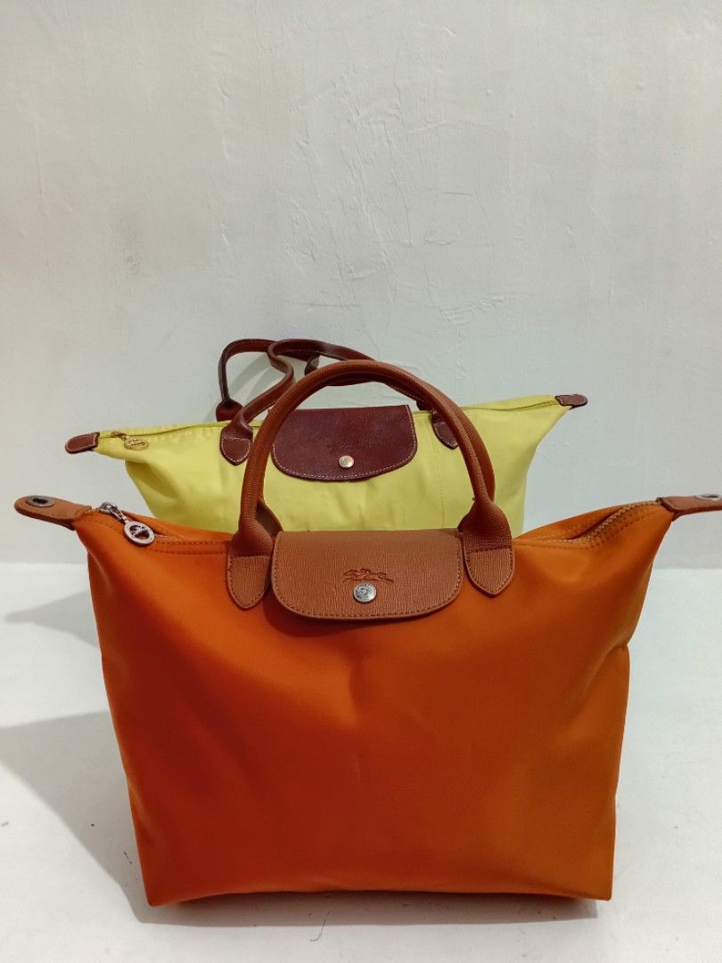 LONGCHAMP PLIAGE NEO MEDIUM in Cognac (Category: Luxury Bags & Wallets) located in Navotas City. Submitted by ms.soulana (Listing ID 1444921131, Image 2). Description: PREOWNED Lightly Used LONGCHAMP PLIAGE NEO MEDIUM Top handle bag in COGNAC wth Original Detachable Strap MEDIUM Length 12 "X height 11" X depth 6.5" Cognac Colorway wth hard jelly tag intact inside Made in Tunisia No Rubs on Nylon ,No Damage sa Corners ,Edge . Flaws: Minimal tarnis