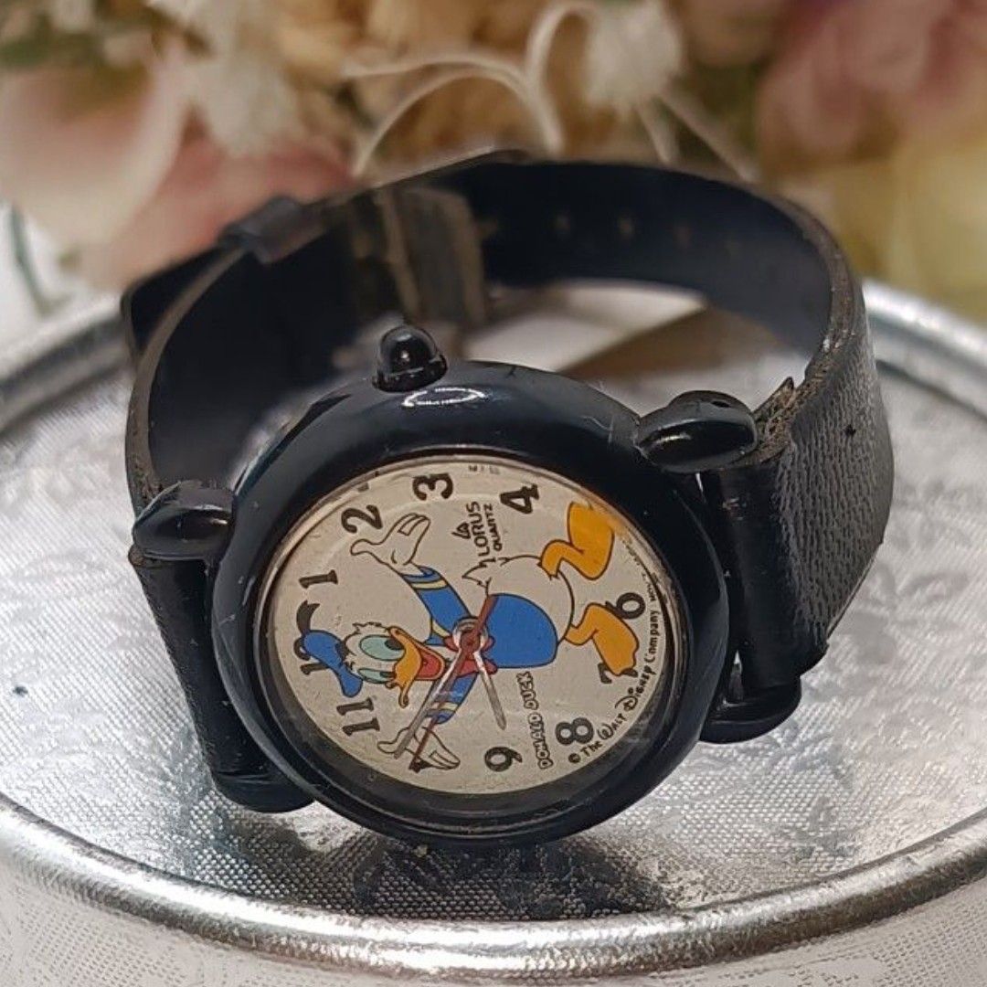 Lorus Quartz Donald Duck Watch (Category: Men's Watches) located in Cagayan de Oro. Submitted by mmmdshop (Listing ID 1450510951, Image 1). Description: - Vintage Lorus Quartz Watch - Features a fun Donald Duck design on the face - Black leather strap - Perfect for collectors or Disney enthusiasts -Needs new battery - Shows some signs of wear on the strap and casing.