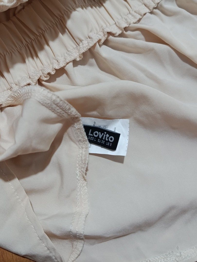 Lovito Women Elegant Halter Neck Top (Category: Sleeveless) located in Quezon City. Submitted by addyyy19 (Listing ID 1450468397, Image 2). Description: - Lovito cream halter neck top - Elasticated waist for a flattering fit - Ties at the back of the neck - Versatile for night outs or casual days - Pairs well with jeans or skirts.