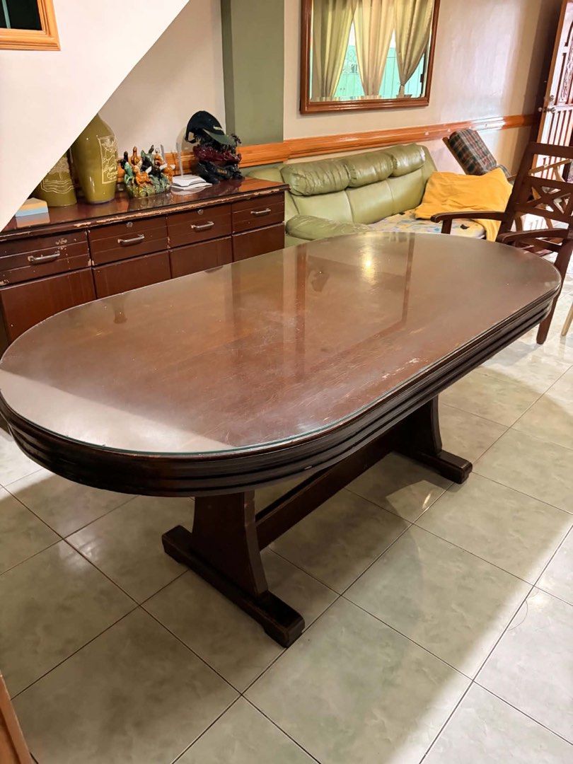 Dining Table with Glass Top (Category: Tables & Sets) located in Pasay City. Submitted by randomshiz_ (Listing ID 1450394121, Image 1). Description: Mahogany Table with Glass Top 2nd hand good condition 71.5 x 35 inches - Solid wood oval dining table - Includes glass top - Wood shows scratches and wear from use - Sturdy base - Perfect for family meals and gatherings - if oick up less 1k na Pick up or lalamove shoulder by the buyer. QC area Not ru