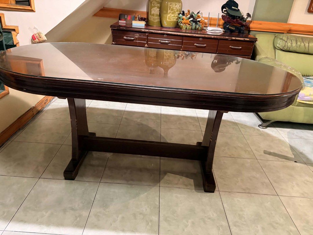 Dining Table with Glass Top (Category: Tables & Sets) located in Pasay City. Submitted by randomshiz_ (Listing ID 1450394121, Image 3). Description: Mahogany Table with Glass Top 2nd hand good condition 71.5 x 35 inches - Solid wood oval dining table - Includes glass top - Wood shows scratches and wear from use - Sturdy base - Perfect for family meals and gatherings - if oick up less 1k na Pick up or lalamove shoulder by the buyer. QC area Not ru