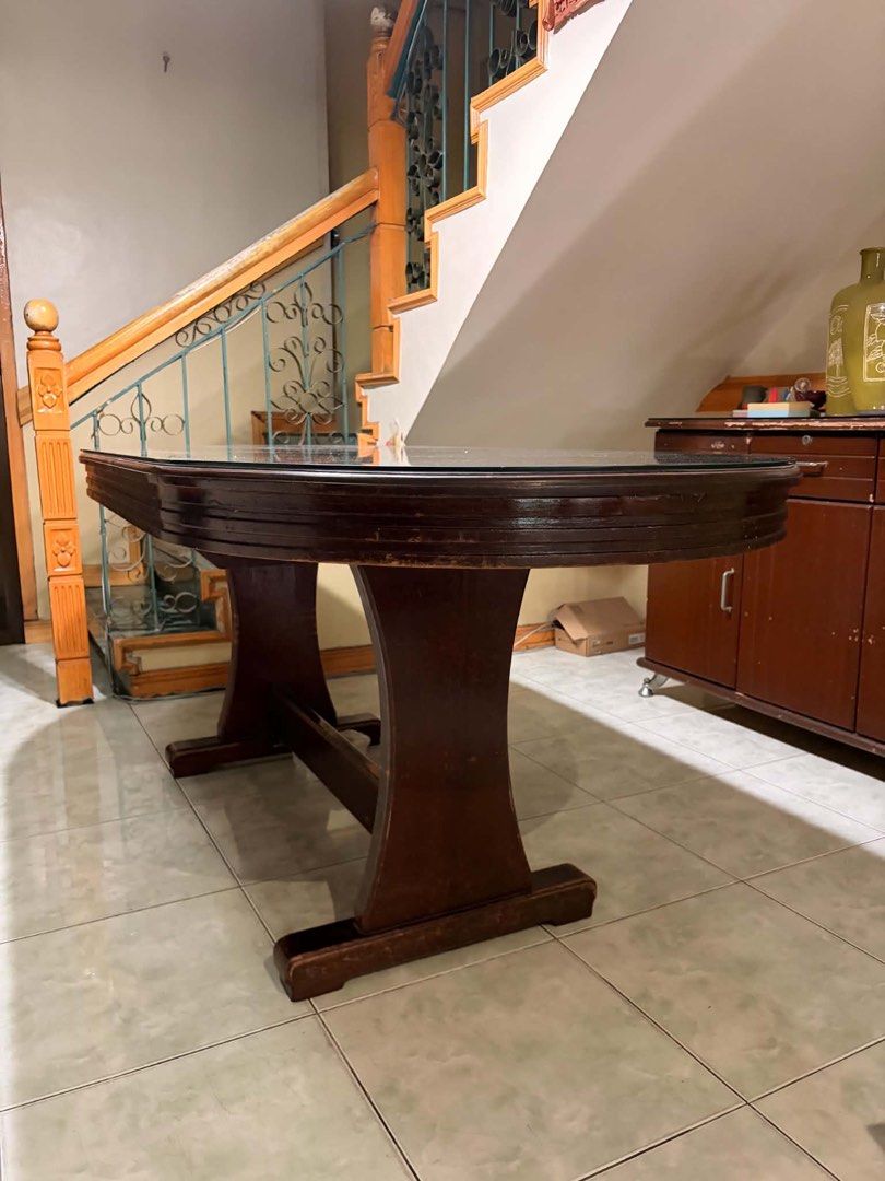 Dining Table with Glass Top (Category: Tables & Sets) located in Pasay City. Submitted by randomshiz_ (Listing ID 1450394121, Image 2). Description: Mahogany Table with Glass Top 2nd hand good condition 71.5 x 35 inches - Solid wood oval dining table - Includes glass top - Wood shows scratches and wear from use - Sturdy base - Perfect for family meals and gatherings - if oick up less 1k na Pick up or lalamove shoulder by the buyer. QC area Not ru
