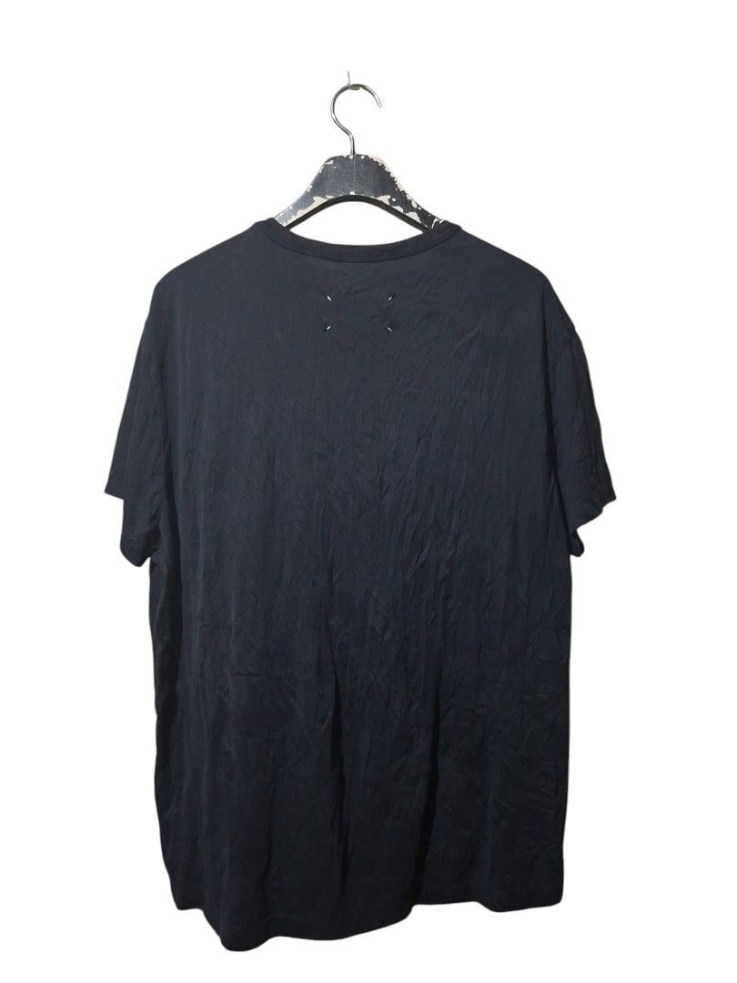 Maison Margiela (Category: Luxury Apparel) located in Leyte. Submitted by jpsrvd19 (Listing ID 1450454443, Image 2). Description: -Maison Margiela Black T-Shirt - Size: 48 - Iconic four-stitch detail on the back - Small embroidered logo on the front - Made in Italy - Perfect staple piece for any wardrobe.