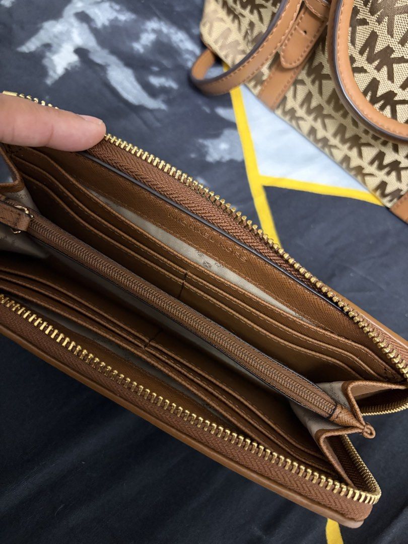 Michael Kors Monogram Handbag and Wallet Set (Category: Luxury Bags & Wallets) located in Quezon City. Submitted by primarosa20 (Listing ID 1450387244, Image 3). Description: - Michael Kors monogram print handbag and matching wallet - Classic brown and tan colorway - Handbag features top handles and a detachable strap - Wallet has multiple card slots and compartments - Ideal set for everyday use.