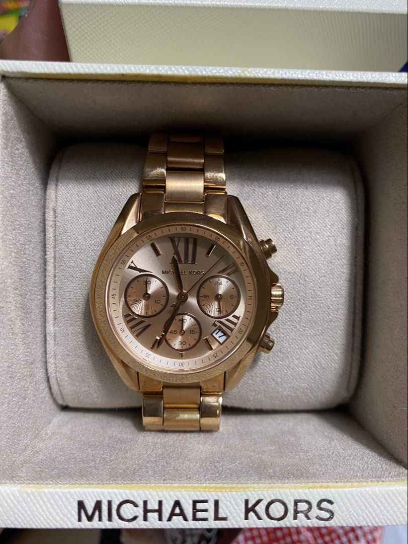 Michael Kors Rose Gold Chronograph Watch (Category: Luxury Watches) located in Pasig City. Submitted by elise.ensembles28 (Listing ID 1419799673, Image 1). Description: Michael Kors Bradshaw Rose Gold Stainless Steel Watch (MK5799), featuring a rose gold-toned dial and a 37mm case. Brand/Model: Michael Kors MK5799 Bradshaw. Material: Rose gold-plated stainless steel. Features: Chronograph functionality with a date display at 3 o’clock. Case Size: