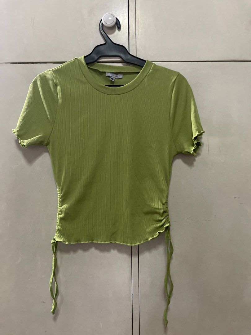Milkshake Lime Green Ruched Drawstring T-shirt (Category: Shirts) located in Quezon City. Submitted by lespyjamas (Listing ID 1450400691, Image 1). Description: - Brand: Milkshake - Color: Lime Green - Fabric: Ribbed - Details: Lettuce hem on sleeves and bottom, side ruching with adjustable drawstring ties - Neckline: Crew neck - Sleeves: Short sleeves.