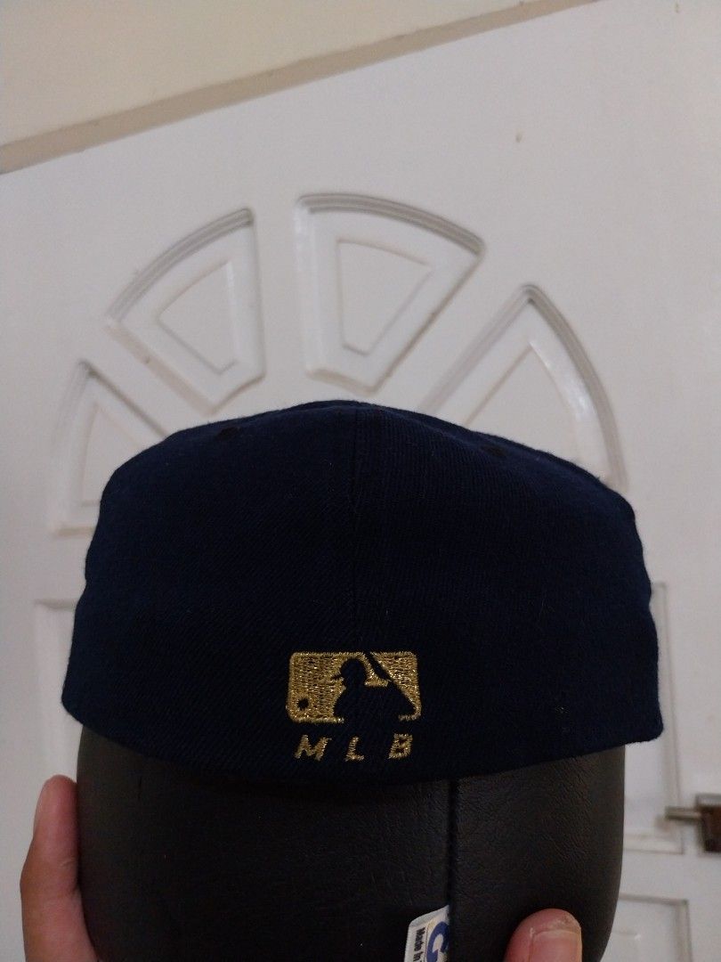 New Era MLB Navy Blue Baseball Cap (Category: Caps & Hats) located in Davao. Submitted by thegraildept2026 (Listing ID 1450391409, Image 2). Description: - Navy blue baseball cap - Features gold embroidery on the side and back - MLB logo clearly visible - Interior also shows MLB logos and text - Ideal for any baseball enthusiast.