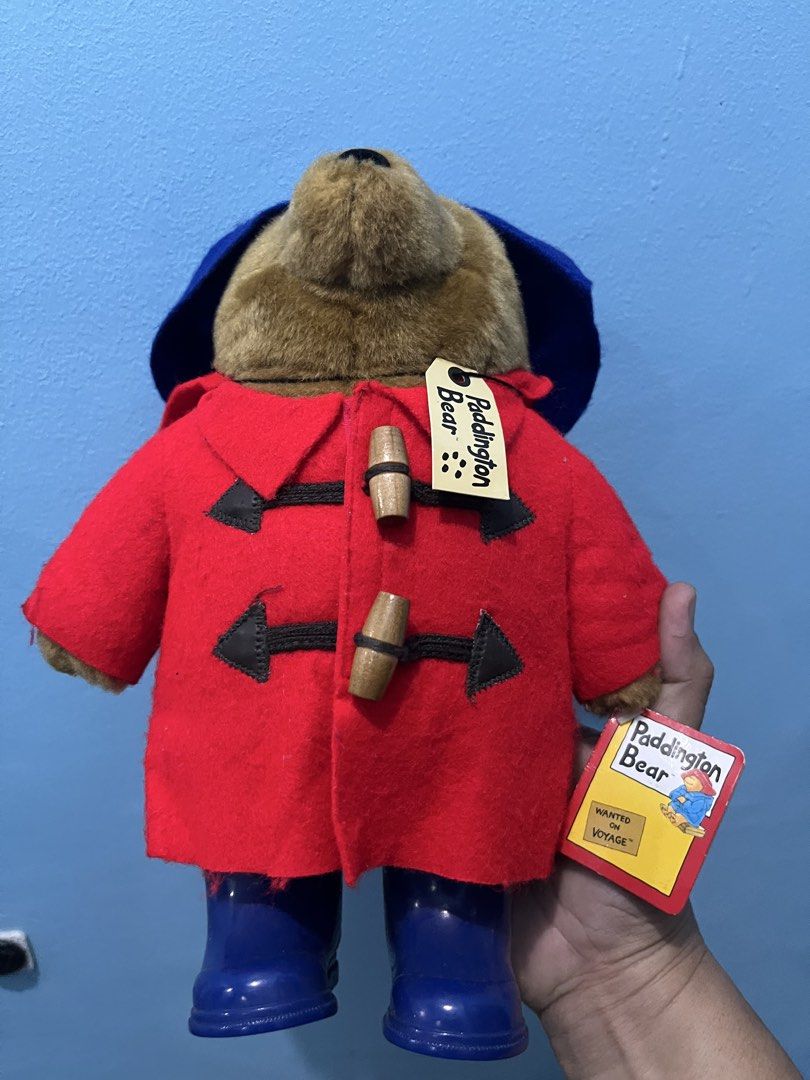 Padington Bear 12inches (Category: Plushies & Soft Toys) located in Pasay City. Submitted by beye01 (Listing ID 1450501670, Image 2). Description: The product is a 12” Paddington Bear stuffed animal with wooden buttons and rubber boots, released in 2005 as a new French issue. It features the iconic character of Paddington Bear from the franchise, made by the brand Augusta Du Bay. The bear is tan in color and suitable for all occasions. This colle