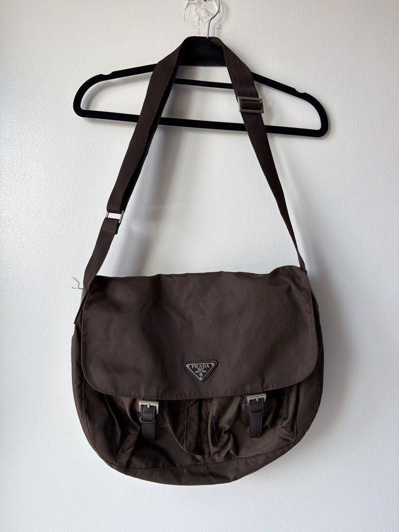 Prada Brown Nylon Messenger Shoulder Bag y2K (Category: Luxury Bags & Wallets) located in Makati City. Submitted by cheapipie (Listing ID 1450330938, Image 1). Description: - NGA Prada bag bought in a vintage store in Upper West Side Manhattan 2009 - Color: Brown - Material: Nylon - Iconic Prada triangle logo - Buckle closures on front flap - Interior zip pocket - Adjustable shoulder strap - Ideal for everyday use.