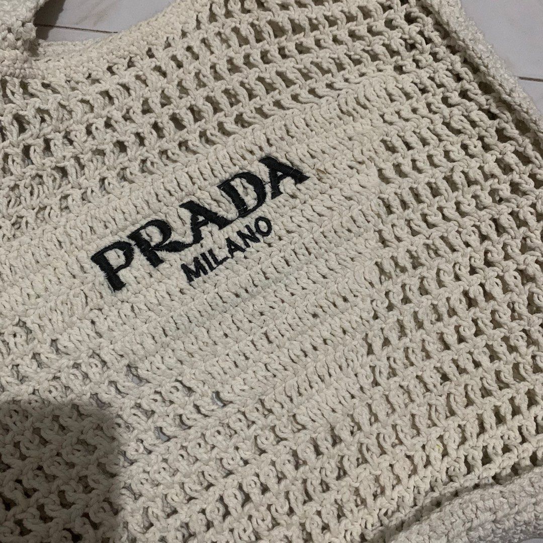 PRADA Milano Logo Embroidered Raffia Tote Bag (Category: Luxury Bags & Wallets) located in Manila. Submitted by shuks30 (Listing ID 1450360874, Image 2). Description: - White raffia tote bag - Features PRADA MILANO logo - Hand-crocheted style - Ideal for beach days or everyday use - Spacious interior - Comfortable straps - Price is negotiable for sure buyers .