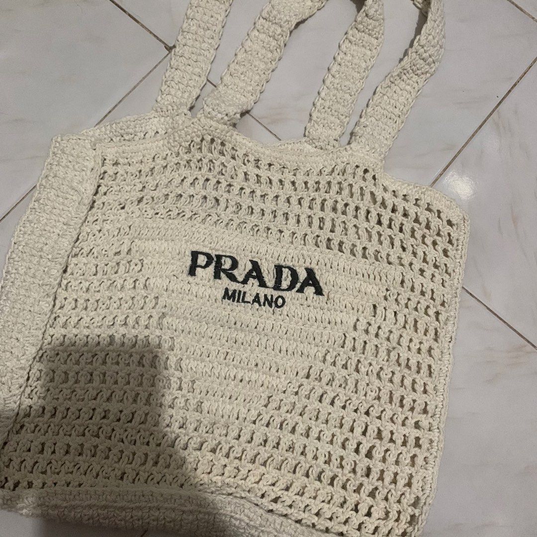 PRADA Milano Logo Embroidered Raffia Tote Bag (Category: Luxury Bags & Wallets) located in Manila. Submitted by shuks30 (Listing ID 1450360874, Image 1). Description: - White raffia tote bag - Features PRADA MILANO logo - Hand-crocheted style - Ideal for beach days or everyday use - Spacious interior - Comfortable straps - Price is negotiable for sure buyers .
