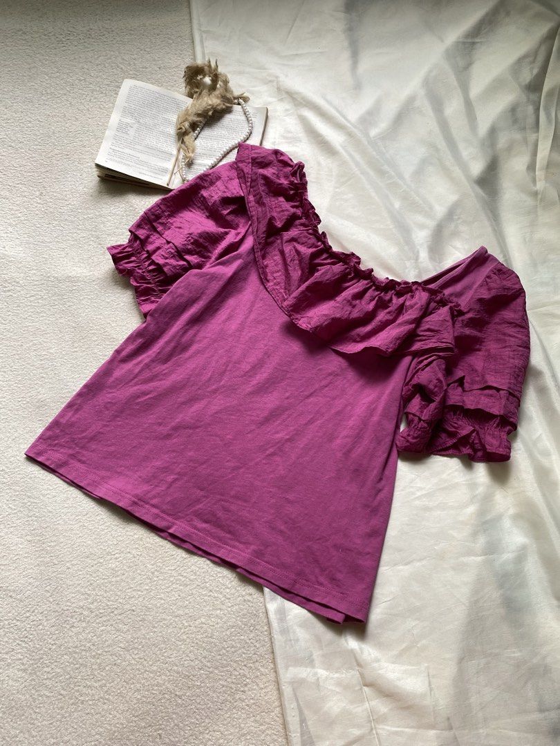 Purple Square Neck Ruffle Puff Sleeve Top Small Bust 34 (Category: Blouses) located in Poro. Submitted by joyceyuu (Listing ID 1450523712, Image 3). Description: - Adorable purple top - Features a chic square neckline - Delicate ruffled details across the chest - Stylish puff sleeves with tiered ruffles at the ends - Fabric has a subtle texture - Perfect for both casual outings and dressier events.