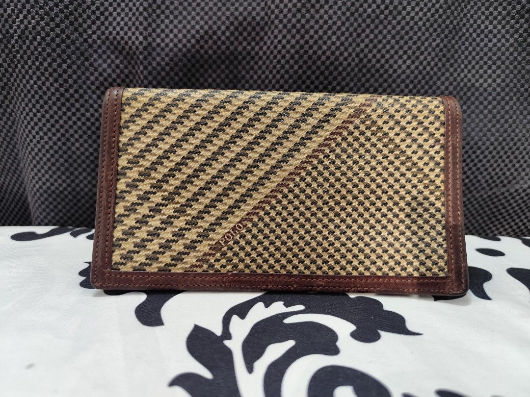 Ralph Lauren bi fold long wallet (Category: Luxury Bags & Wallets) located in Santa Rosa. Submitted by ahroncatpad (Listing ID 1450415099, Image 1). Description: Ralph Lauren bi fold ling wallet brown houndstooth canvas with leather trimming 5 card slot working zipper no bakbak leather conditioner needed.