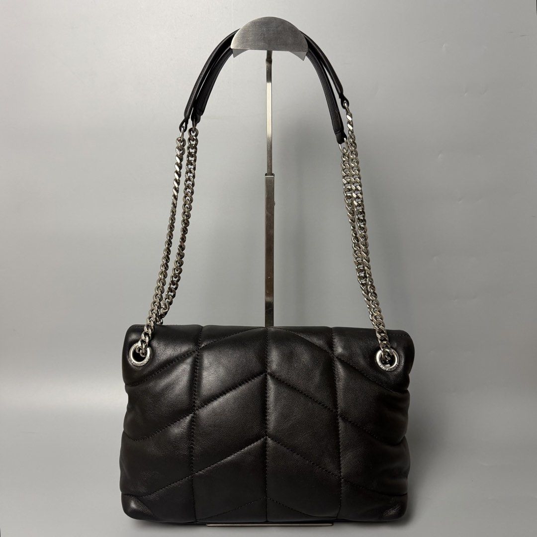Saint Laurent Black Leather Puffer Shoulder Bag (Category: Luxury Bags & Wallets) located in Malasiqui. Submitted by fosh0fosh0 (Listing ID 1450335978, Image 2). Description: - Authentic Yves Saint Laurent (YSL) Puffer Bag - Material: Black Leather - Hardware: Silver Chain Strap - Design: Classic Quilted Pattern - Versatile: Ideal for both daytime and evening use - Interior: Spacious with a clean lining - Includes: Original dustbag.