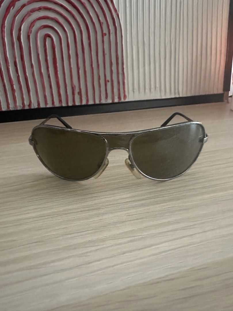Salvatore Ferragamo Aviator Sunglasses (Category: Sunglasses & Eyewear) located in Quezon City. Submitted by heiressofpersia80 (Listing ID 1450351810, Image 2). Description: - Authentic Salvatore Ferragamo aviator sunglasses - Sleek silver frame - Dark tinted lenses for a classic look - Ideal for everyday wear Unisex Authentic pair of vintage S@lv@tore Ferr@gamo Model Number: 1094 Color Code: 502/73 metallic silver frame paired with Green or dark