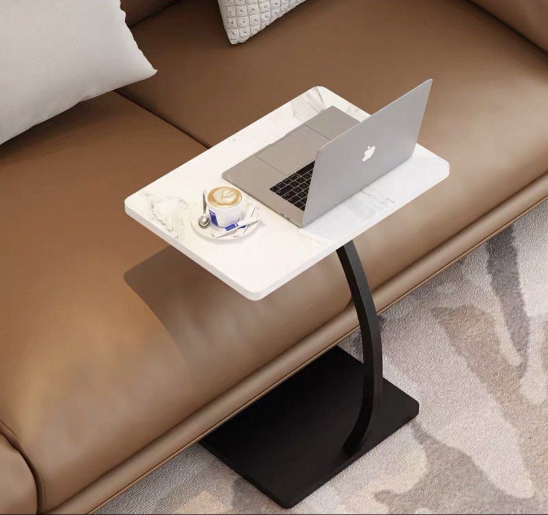 Side table (Category: Tables & Sets) located in Singapore. Submitted by xh2512 (Listing ID 1450499374, Image 1). Description: - Modern C-table design - White marble-look tabletop - Black curved metal leg - Sturdy rectangular base - Easy to slide under furniture - Compact and functional.
