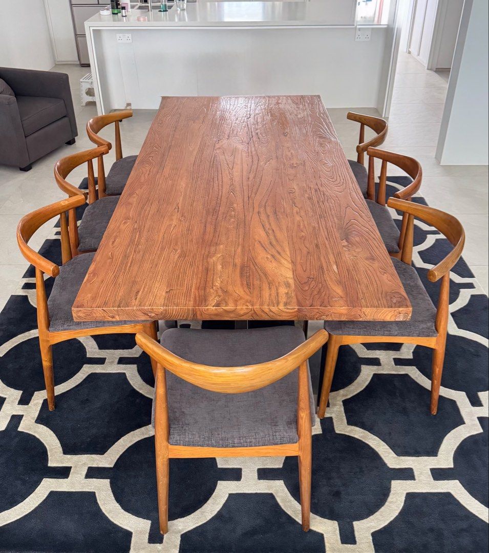Solid Wood Dining Table (Category: Tables & Sets) located in Singapore. Submitted by localmarketboy (Listing ID 1450369158, Image 3). Description: - Solid wood dining table with unique textured top - Sturdy metal base - Seats 6-8 people comfortably - Includes 6 comfortable chairs with grey upholstered seats - Wooden chair frames - Perfect centerpiece for your dining room - Ideal for family meals and entertaining guests Custom Solid Wood Dining Ta