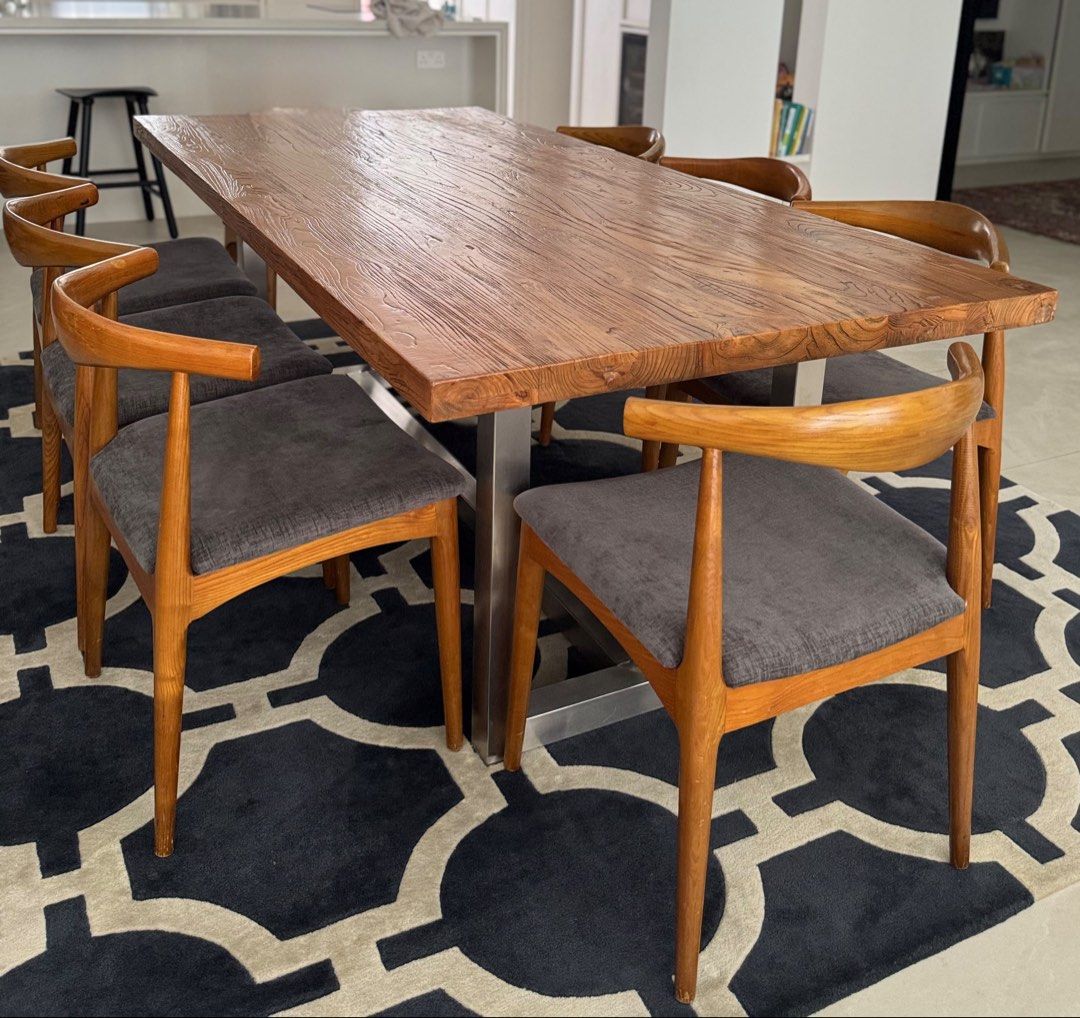 Solid Wood Dining Table (Category: Tables & Sets) located in Singapore. Submitted by localmarketboy (Listing ID 1450369158, Image 2). Description: - Solid wood dining table with unique textured top - Sturdy metal base - Seats 6-8 people comfortably - Includes 6 comfortable chairs with grey upholstered seats - Wooden chair frames - Perfect centerpiece for your dining room - Ideal for family meals and entertaining guests Custom Solid Wood Dining Ta