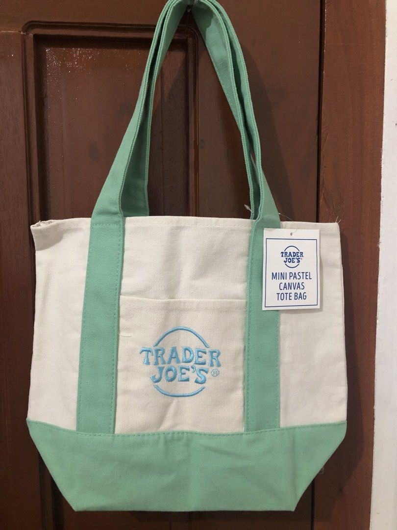 Trader Joe's Mini Pastel Canvas Tote Bag (Category: Tote Bags) located in Porac. Submitted by seoulerph (Listing ID 1450458713, Image 1). Description: Cute cream Trader Joe's mini tote bag with pastel green accents and blue embroidered logo. Features a front pocket. Perfect for essentials and quick trips!.