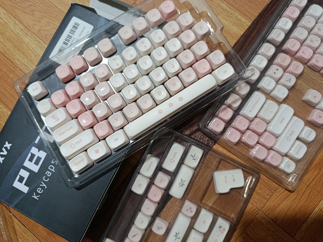 XVX PBT Keycaps Set - Cherry Pudding 143 (Category: Computer Keyboard) located in Quezon City. Submitted by addyyy19 (Listing ID 1450517038, Image 2). Description: - XVX PBT Keycaps - Pink and White colorway - Full set compatible with most mxn - Suitable for ANSI Layouts - Comes with original box HONEST ISSUE: - a bit faded 'WSDA' keys - missing 'end', 'prtsc', and 'home' keys (but can be replaced with other keys) - missing orig keycaps puller .