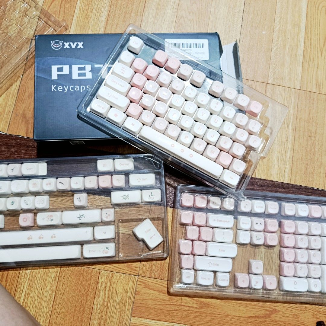 XVX PBT Keycaps Set - Cherry Pudding 143 (Category: Computer Keyboard) located in Quezon City. Submitted by addyyy19 (Listing ID 1450517038, Image 1). Description: - XVX PBT Keycaps - Pink and White colorway - Full set compatible with most mxn - Suitable for ANSI Layouts - Comes with original box HONEST ISSUE: - a bit faded 'WSDA' keys - missing 'end', 'prtsc', and 'home' keys (but can be replaced with other keys) - missing orig keycaps puller .