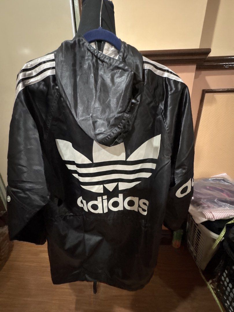 Adidas Black Windbreaker Jacket with Big Logo (Category: Coats, Jackets and Outerwear) located in Manila. Submitted by dig76 (Listing ID 1450603883, Image 2). Description: Please see photo for measurements - Classic black Adidas windbreaker jacket - Iconic Trefoil logo on the back - Adidas spellout on the front - Three stripes on the sleeves - Hooded design - Drawstring waist for adjustable fit - Great for casual wear or sports.