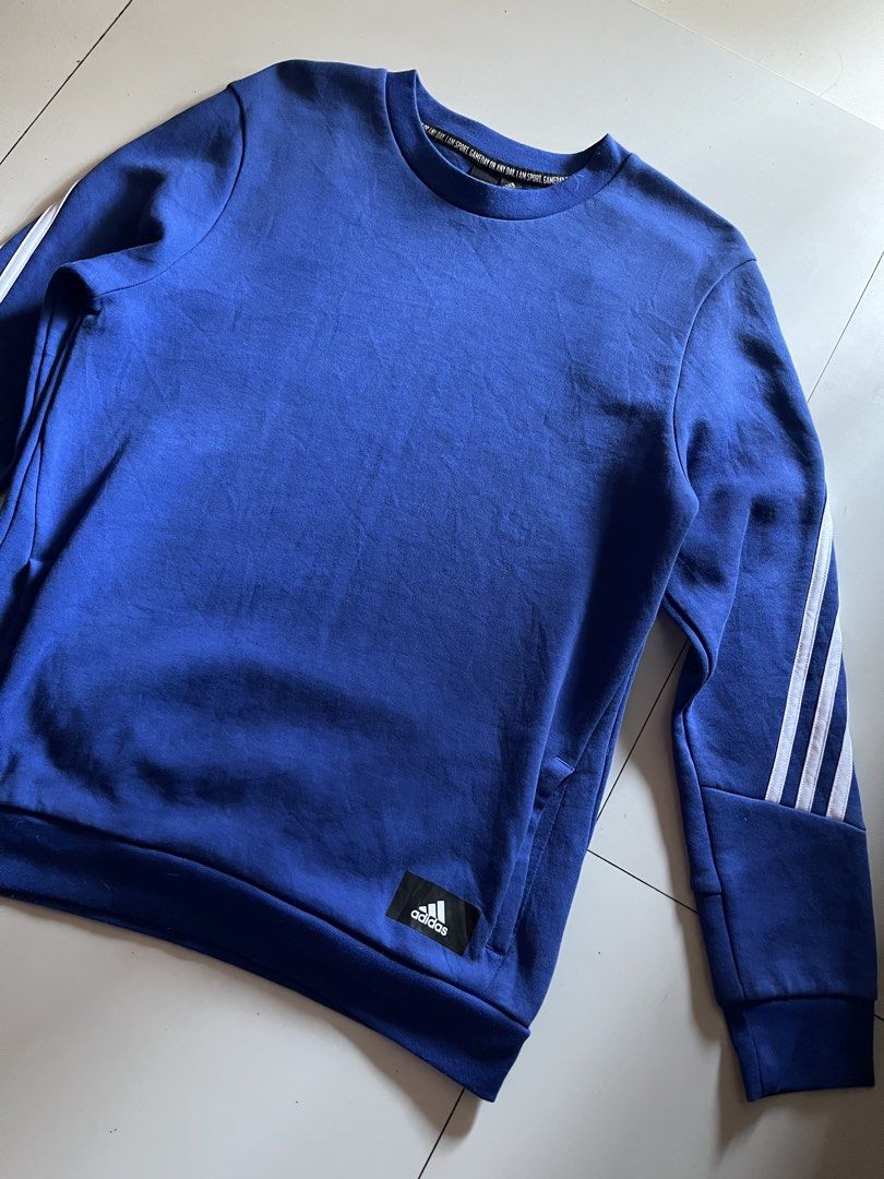 Adidas Pullover Sweater (Category: Coats, Jackets and Outerwear) located in Santa Ana. Submitted by rlave (Listing ID 1450583715, Image 1). Description: Preloved Adidas blue jacket, small size, featuring classic white 3-Stripes detailing along the sleeves and a subtle logo placed at the bottom right corner. Full-zip closure, ribbed cuffs and hem, comfortable relaxed fit — great for layering or everyday casual wear. Item is in good preloved condit