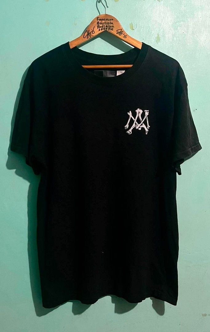 Amiri Black T-Shirt with Bone Logo (Category: Tshirts & Polo Shirts ) located in Abucay. Submitted by chinithou (Listing ID 1450734189, Image 1). Description: - Brand: Amiri - Color: Black - Size: L - Design: Amiri bone logo on front chest, full Amiri logo on back - Material: 98% Cotton, 2% Elastane - Occasion: Casual wear - Condition: Great.