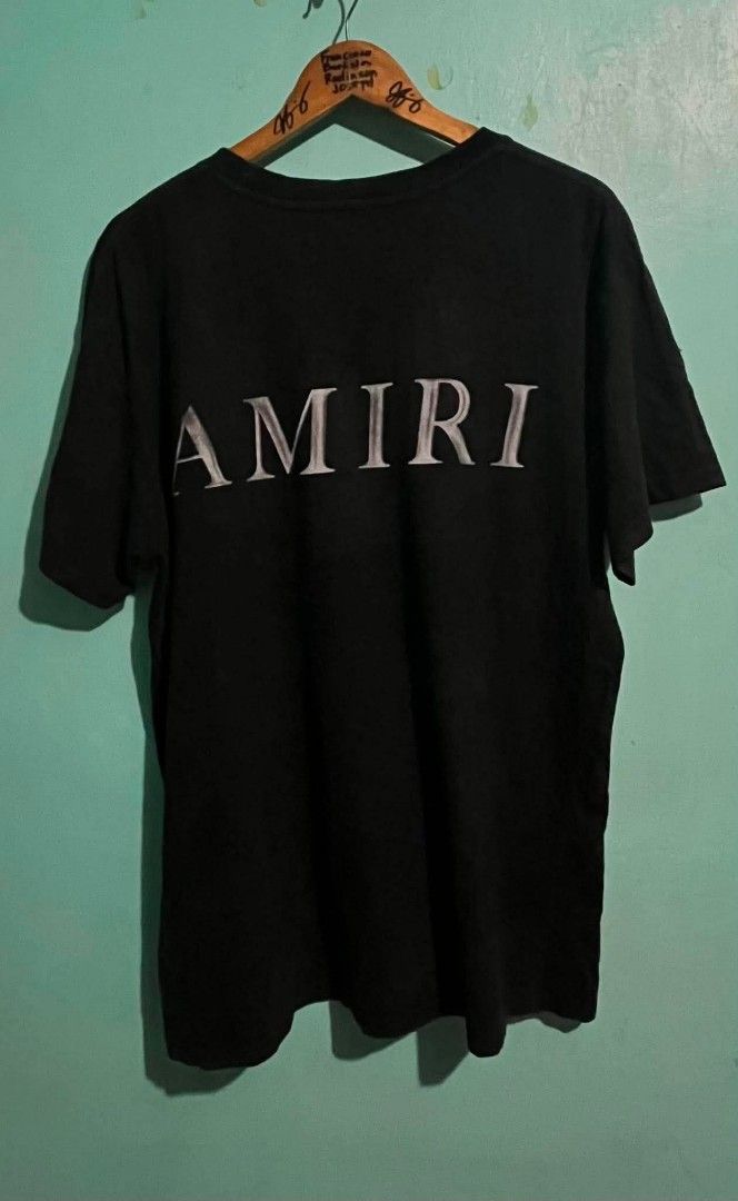 Amiri Black T-Shirt with Bone Logo (Category: Tshirts & Polo Shirts ) located in Abucay. Submitted by chinithou (Listing ID 1450734189, Image 2). Description: - Brand: Amiri - Color: Black - Size: L - Design: Amiri bone logo on front chest, full Amiri logo on back - Material: 98% Cotton, 2% Elastane - Occasion: Casual wear - Condition: Great.