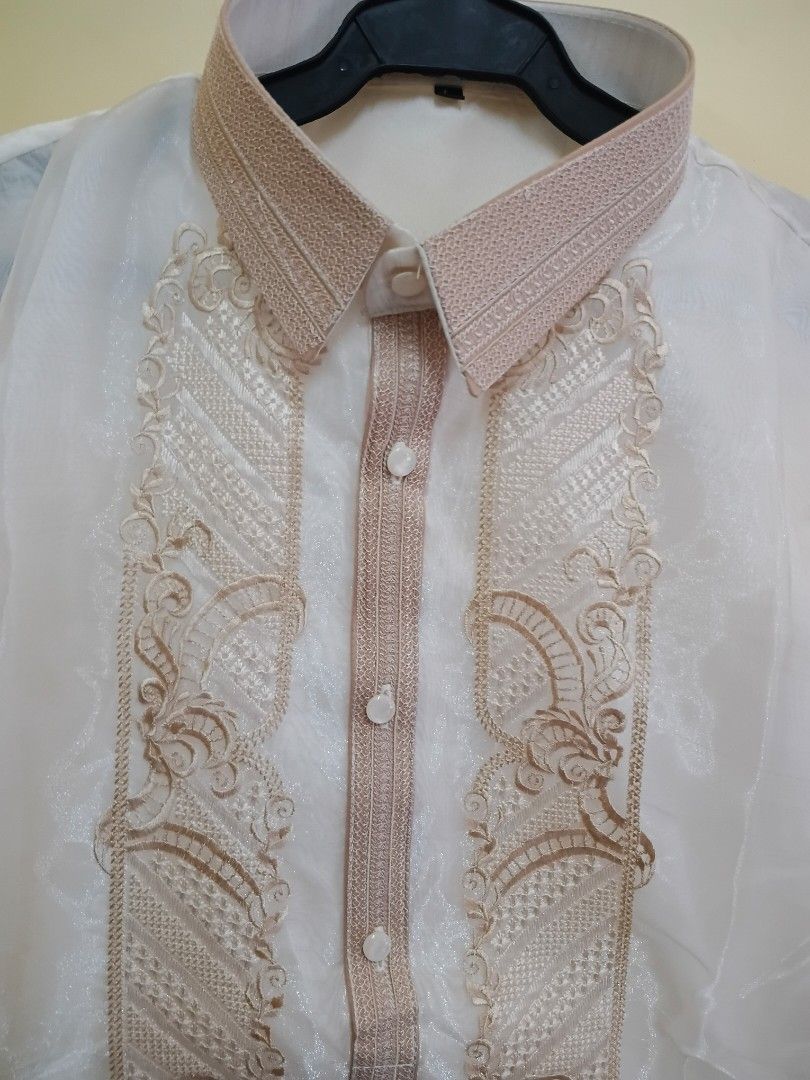 Barong Tagalog with Beige Embroidery (Category: Formal Shirts) located in Binangonan. Submitted by chingtp (Listing ID 1450633910, Image 2). Description: - Traditional Filipino Barong Tagalog - Color: Beige - Fabric: Sheer - Design: Intricate beige embroidery on front and collar - Closure: Button-up - Occasion: Perfect for formal events, cultural celebrations, or special occasions - Condition: Brandnew.