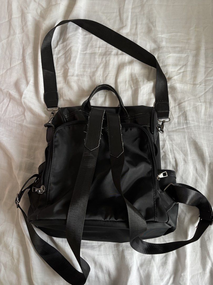 Black Nylon Backpack (Category: Backpacks) located in Manila. Submitted by frncbenz_ (Listing ID 1450677763, Image 2). Description: - Opening is at the back, perfect as non-theft bag - Top handle and adjustable shoulder straps - interior and exterior pockets for organization - Zippers are in good working condition - Well used, still in great condition - No issues.