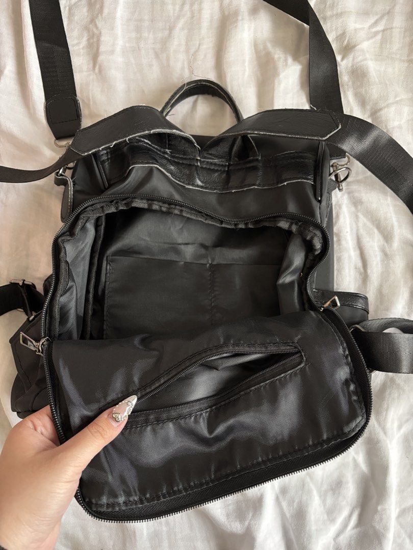 Black Nylon Backpack (Category: Backpacks) located in Manila. Submitted by frncbenz_ (Listing ID 1450677763, Image 3). Description: - Opening is at the back, perfect as non-theft bag - Top handle and adjustable shoulder straps - interior and exterior pockets for organization - Zippers are in good working condition - Well used, still in great condition - No issues.