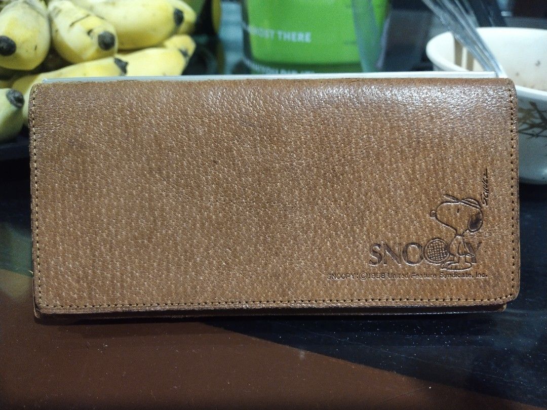 Brown Snoopy Leather Long Wallet (Category: Wallets & Card holders) located in Tuba. Submitted by drickbernard (Listing ID 1450528638, Image 1). Description: - Brown leather long wallet with a cute Snoopy design. - Features multiple card slots for organization. - Includes a zippered compartment for secure storage. - Still fully functional and adds a touch of style to your everyday carry..