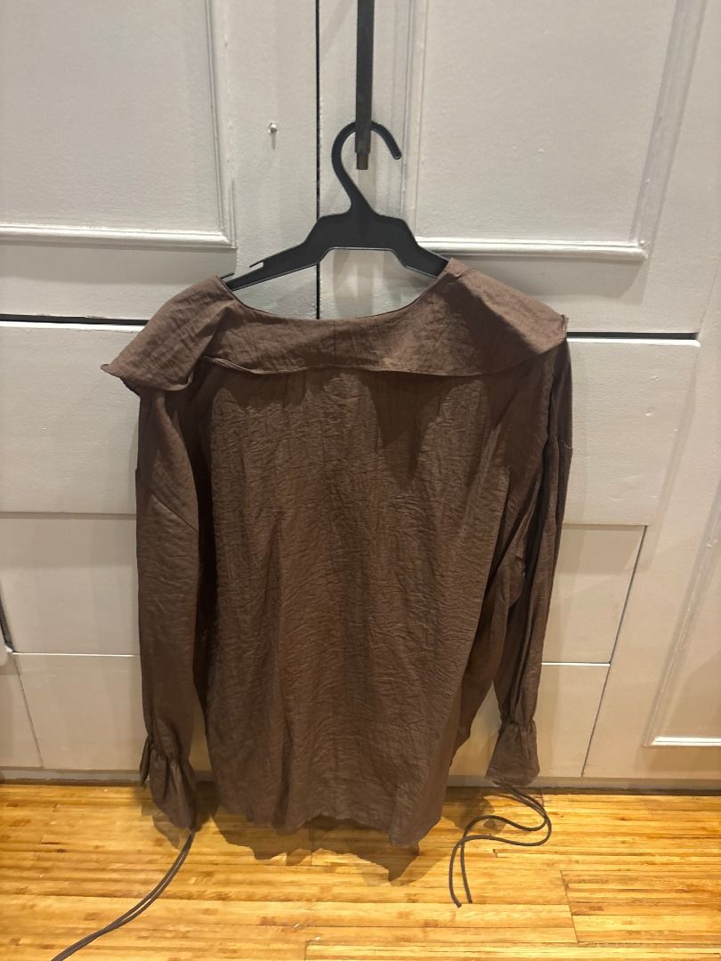 Brown Textured Long Sleeve Blouse with Ruffle Neck (Category: Blouses) located in Quezon City. Submitted by digo_bengzon (Listing ID 1450643823, Image 2). Description: - Brown long sleeve blouse - Unique crinkled texture fabric - Elegant ruffled neckline with tie detail - Cuffs also feature tie details - Perfect for both casual and dressed-up looks - Bought in Bangkok.